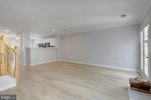 a view of kitchen with refrigerator and window
