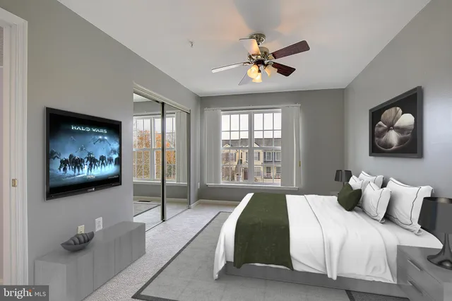 a bedroom with a bed and a painting on the wall