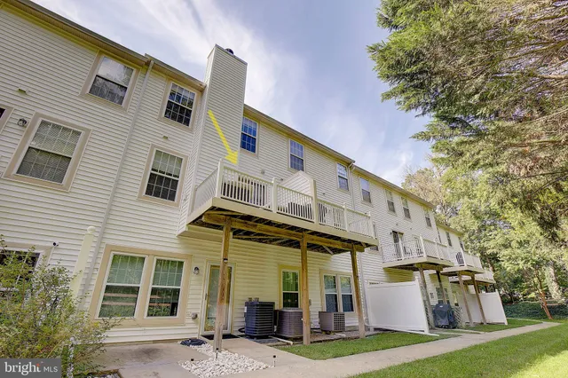 a view of a white house with large windows