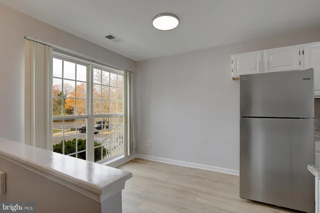 a kitchen with stainless steel appliances a refrigerator and a window