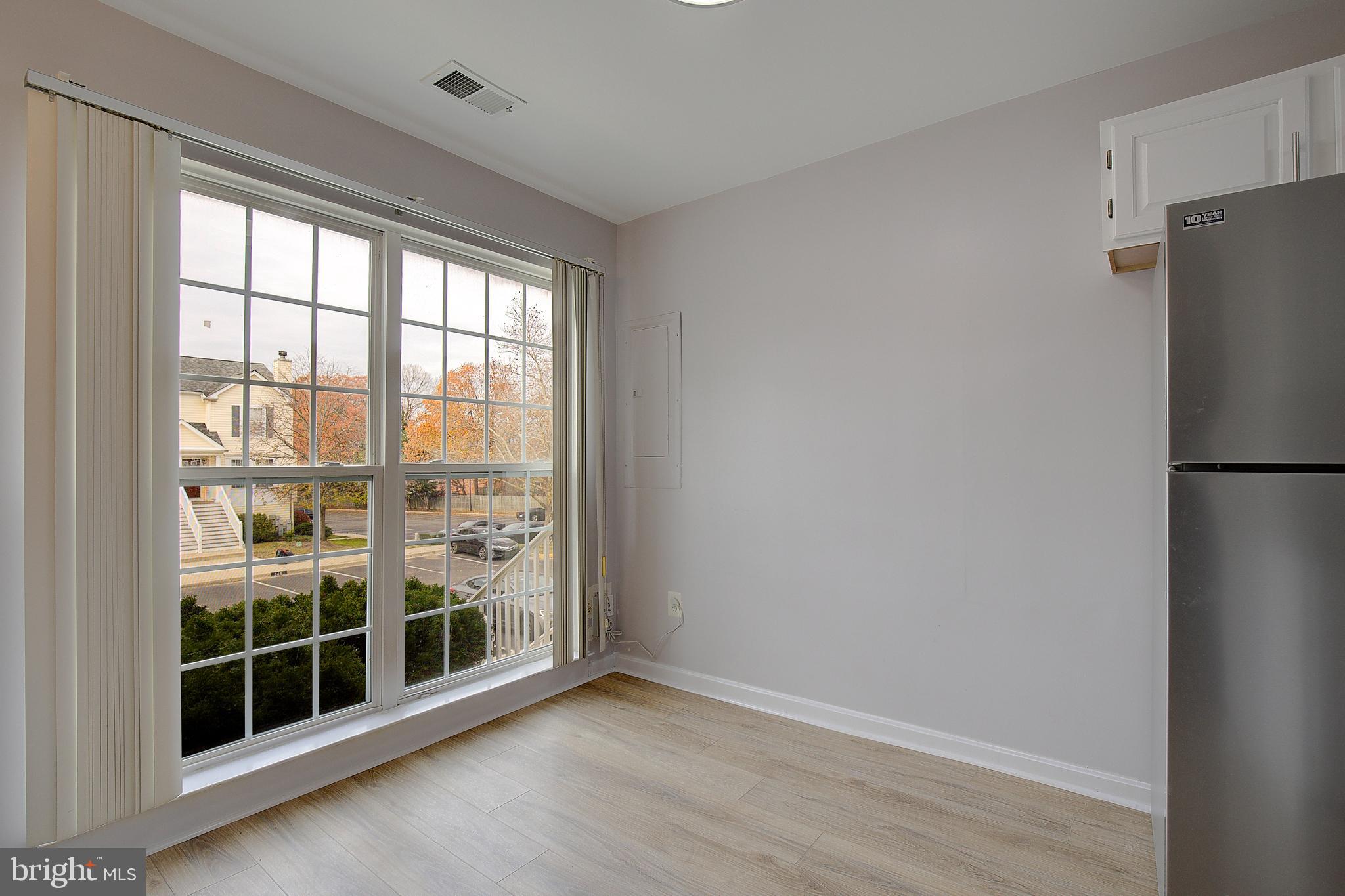 1700 Fallowfield Court Crofton, MD 21114 - Photo 5 of 34 a view of empty room with wooden floor and floor to ceiling window