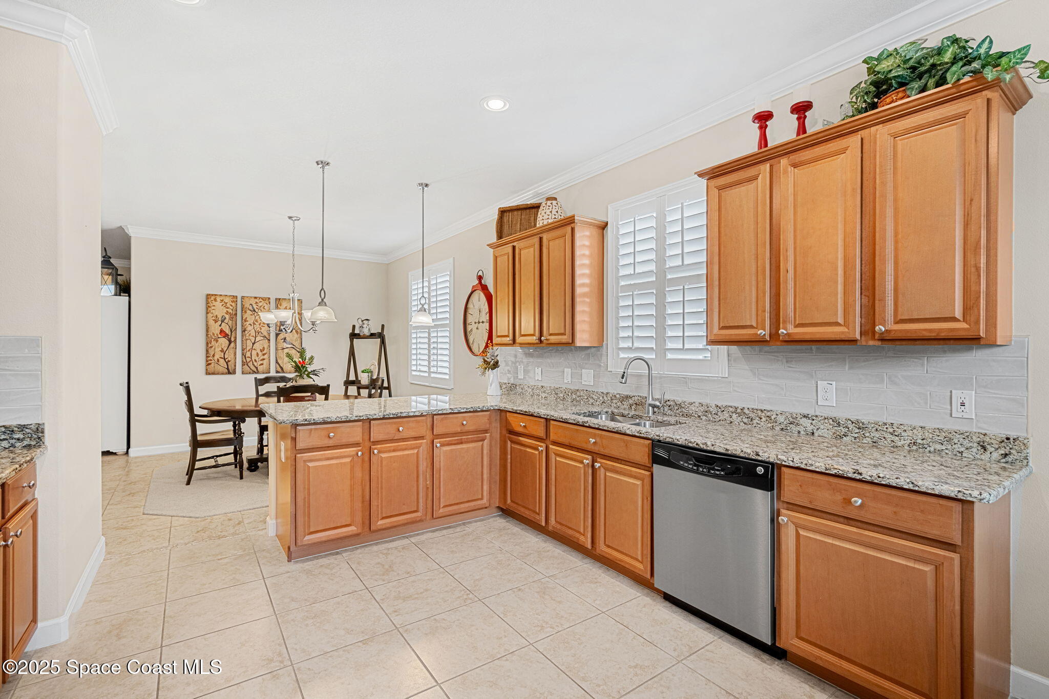 6741 Ringold Street Melbourne, FL 32940 - Photo 11 of 45 a kitchen with stainless steel appliances granite countertop a sink and cabinets