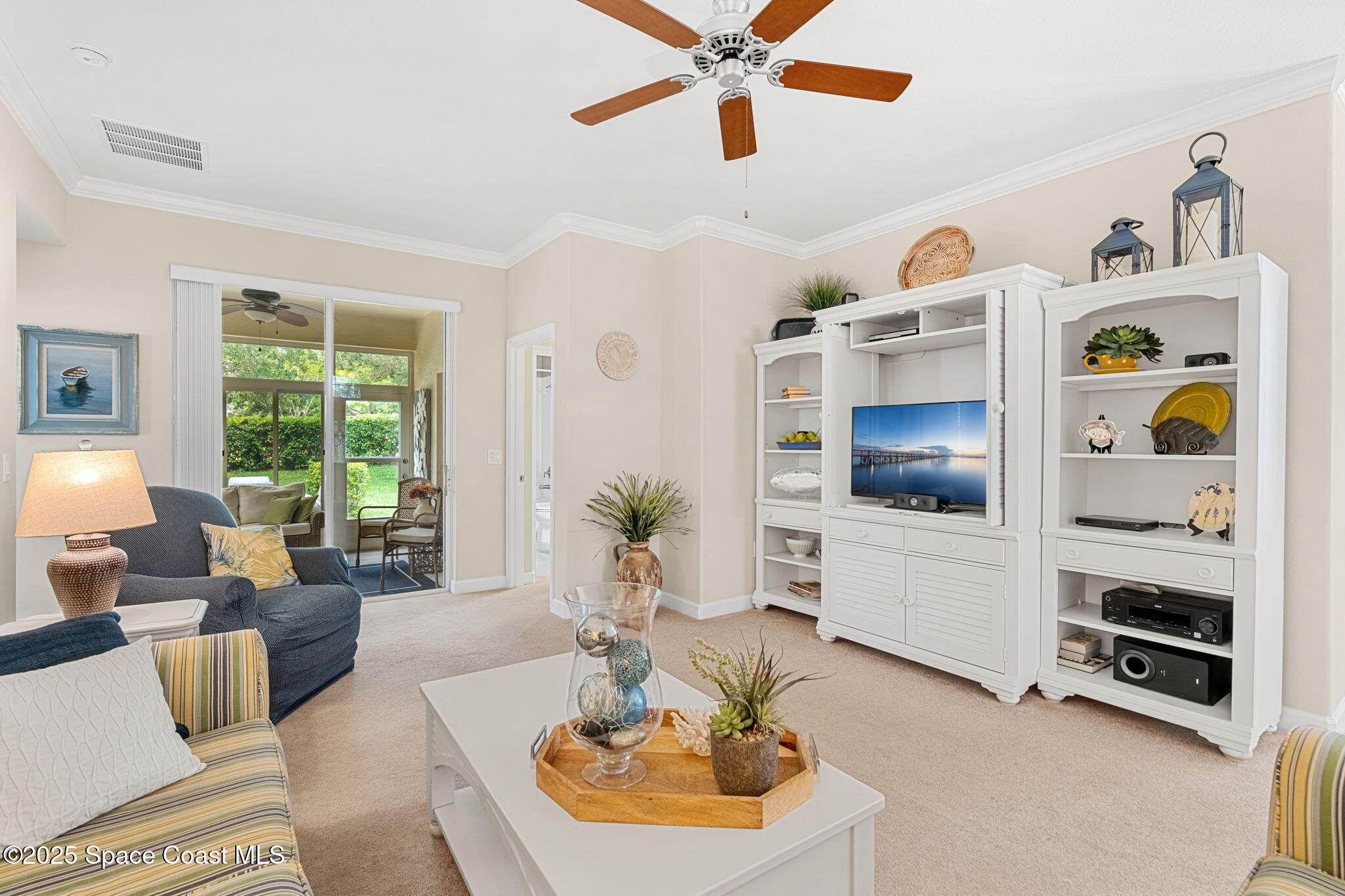 6741 Ringold Street Melbourne, FL 32940 - Photo 13 of 45 a living room with furniture and a flat screen tv