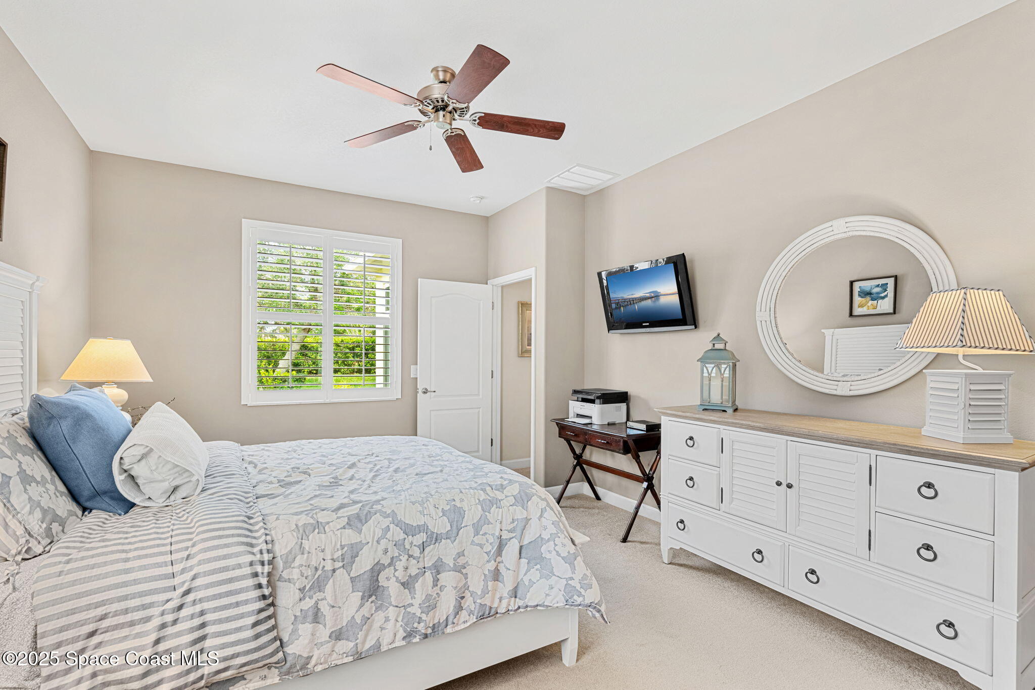 6741 Ringold Street Melbourne, FL 32940 - Photo 15 of 45 a bedroom with a bed a dresser and potted plants on the dresser