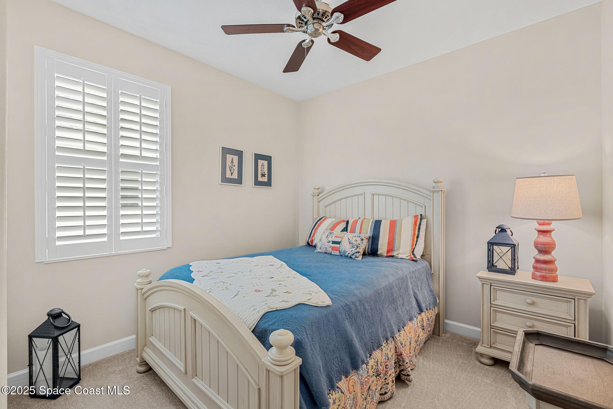 6741 Ringold Street Melbourne, FL 32940 - Photo 20 of 45 a bedroom with a bed and a chandelier