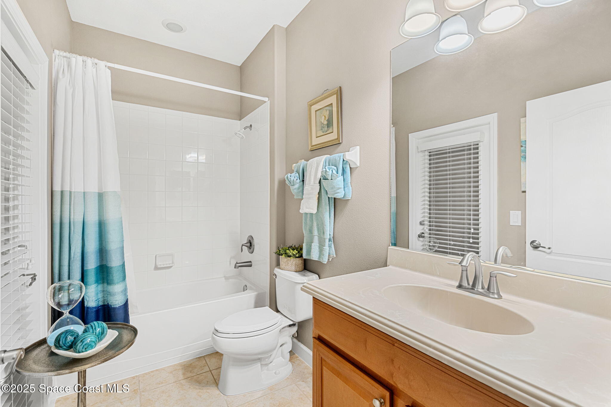 6741 Ringold Street Melbourne, FL 32940 - Photo 21 of 45 a bathroom with a granite countertop sink a toilet a mirror and shower