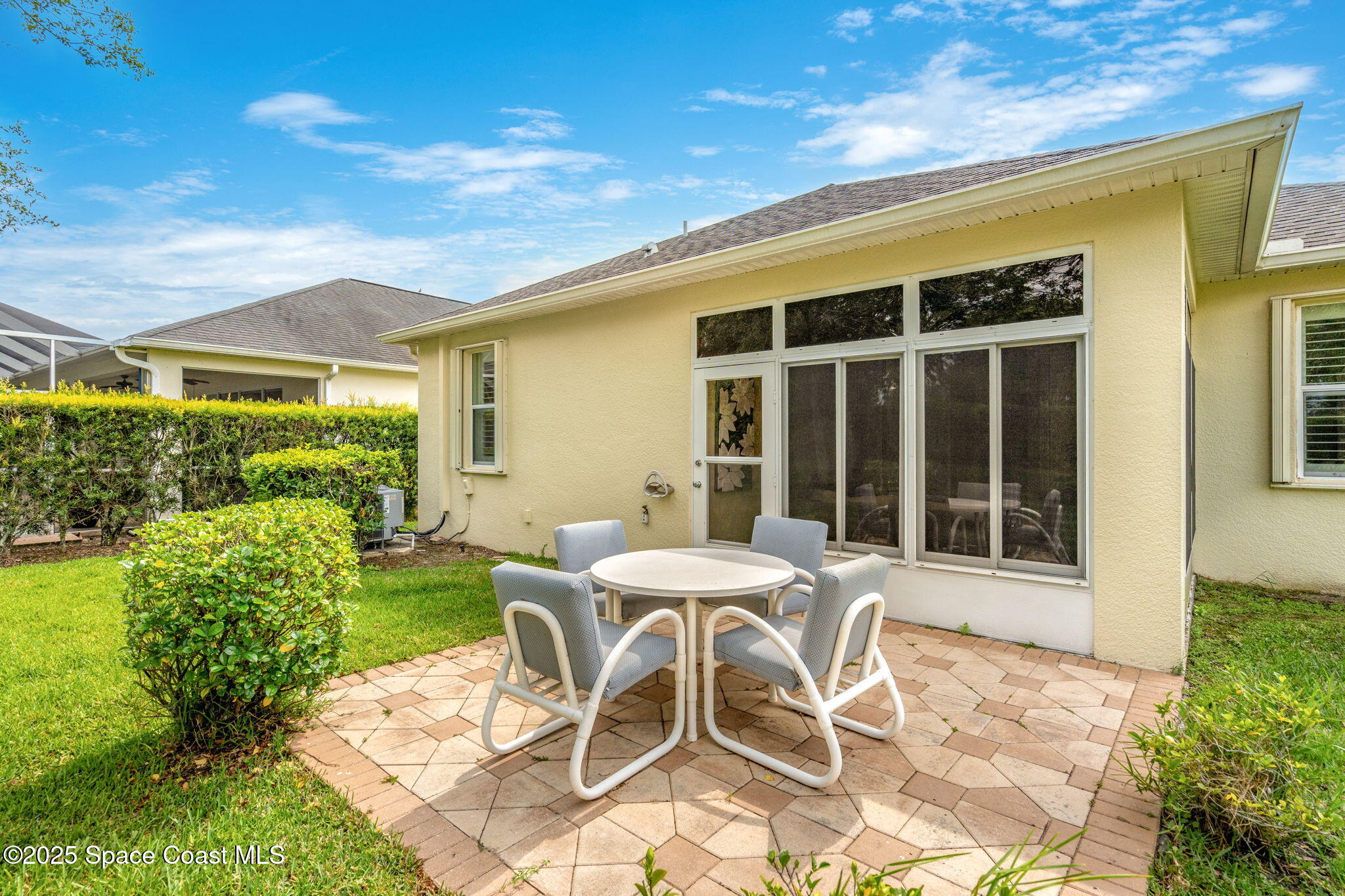 6741 Ringold Street Melbourne, FL 32940 - Photo 25 of 45 a view of a patio with table and chairs with plants and garden