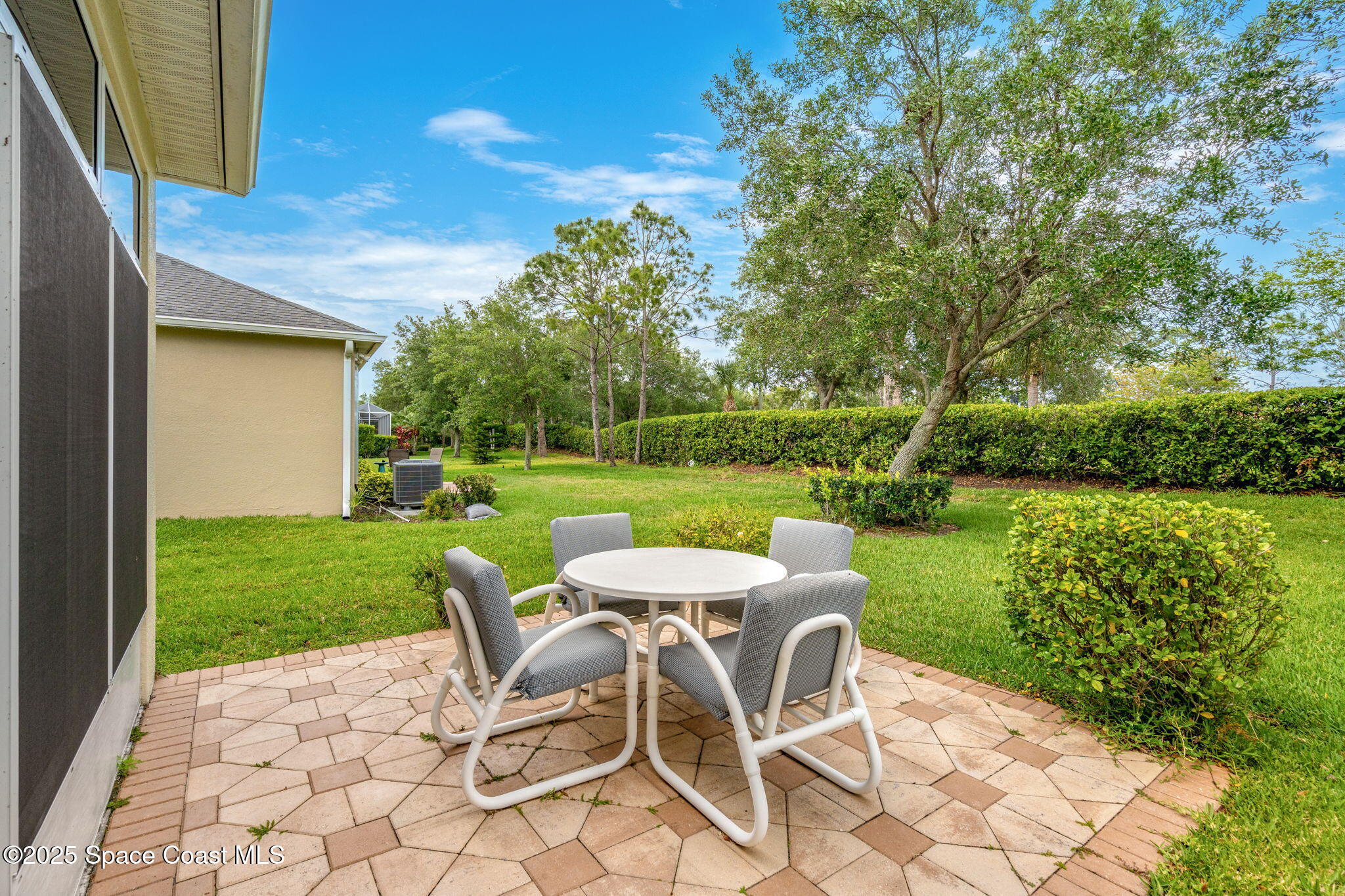 6741 Ringold Street Melbourne, FL 32940 - Photo 26 of 45 a view of a table and chairs in backyard of the house