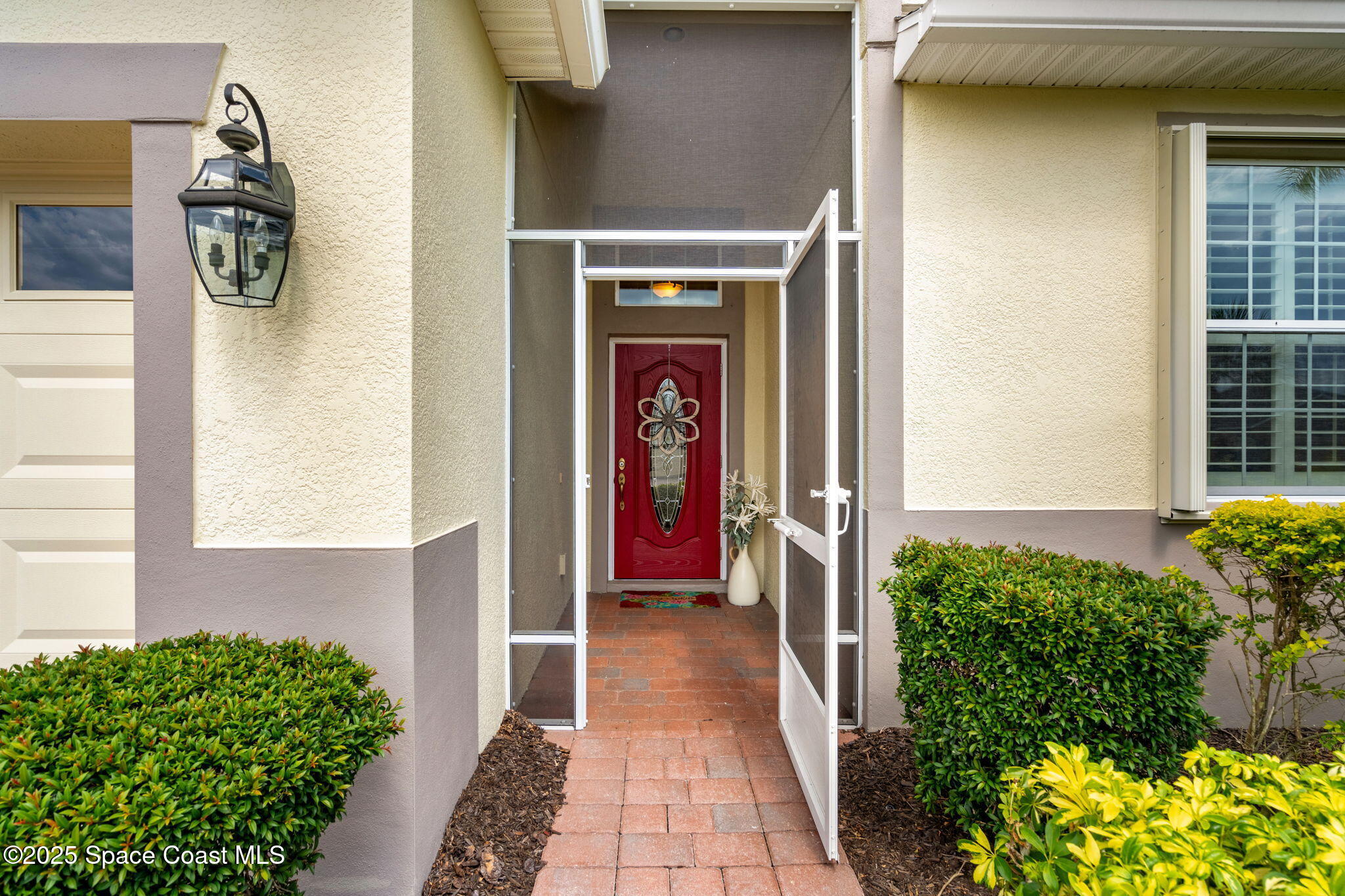 6741 Ringold Street Melbourne, FL 32940 - Photo 3 of 45 a front view of a house with a yard