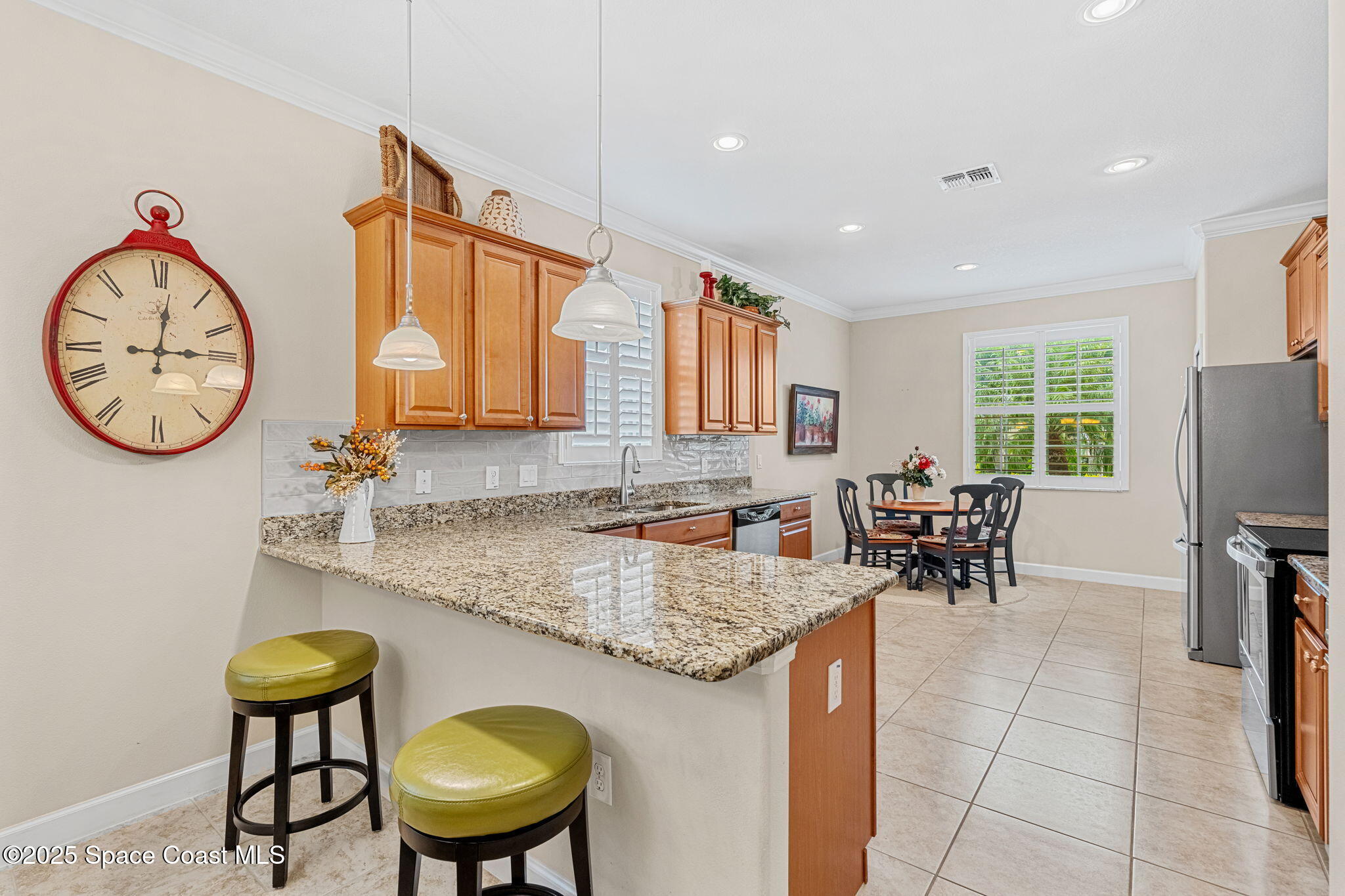 6741 Ringold Street Melbourne, FL 32940 - Photo 7 of 45 a bathroom with a granite countertop sink a mirror and a clock