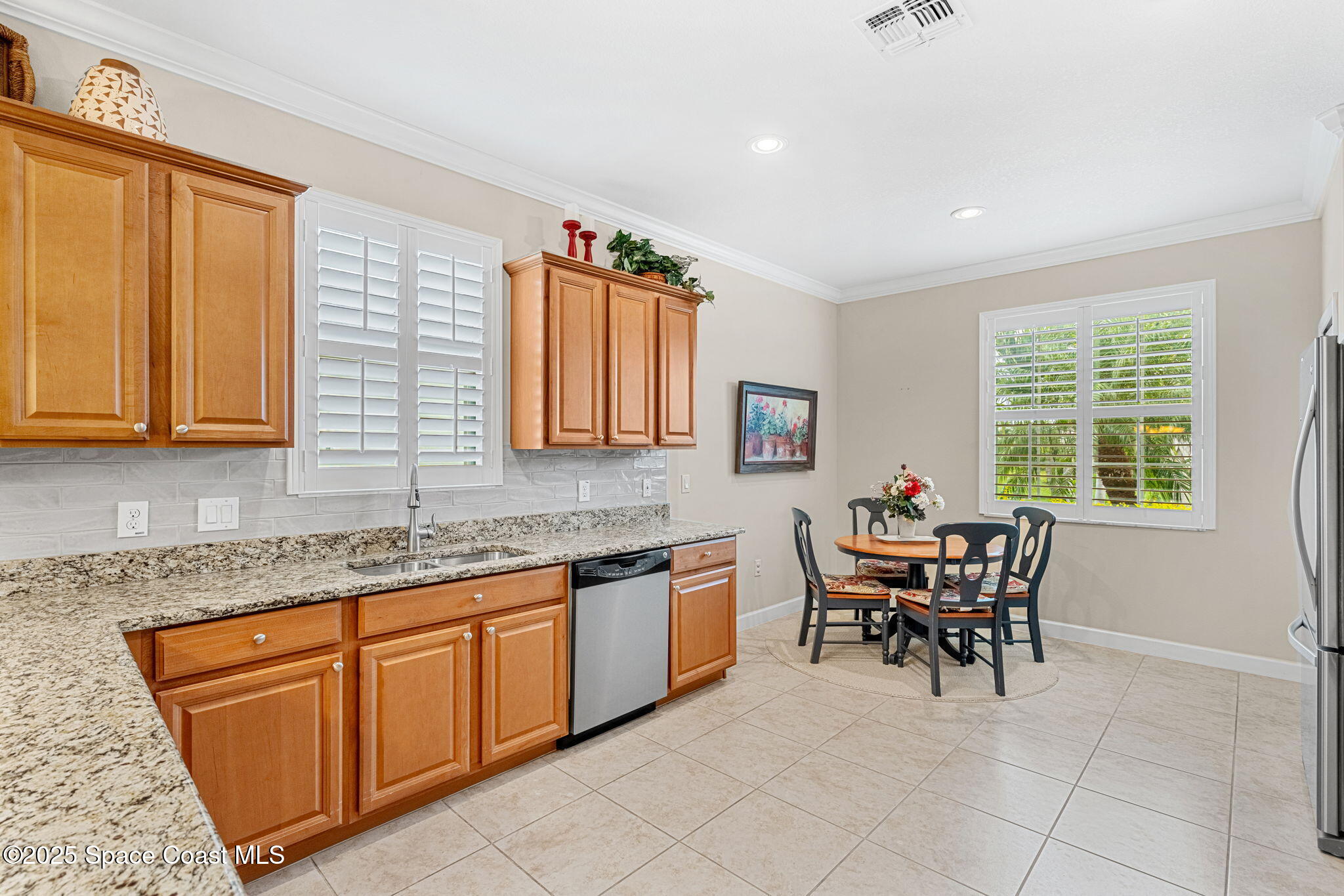 6741 Ringold Street Melbourne, FL 32940 - Photo 8 of 45 a kitchen with granite countertop sink table and chairs