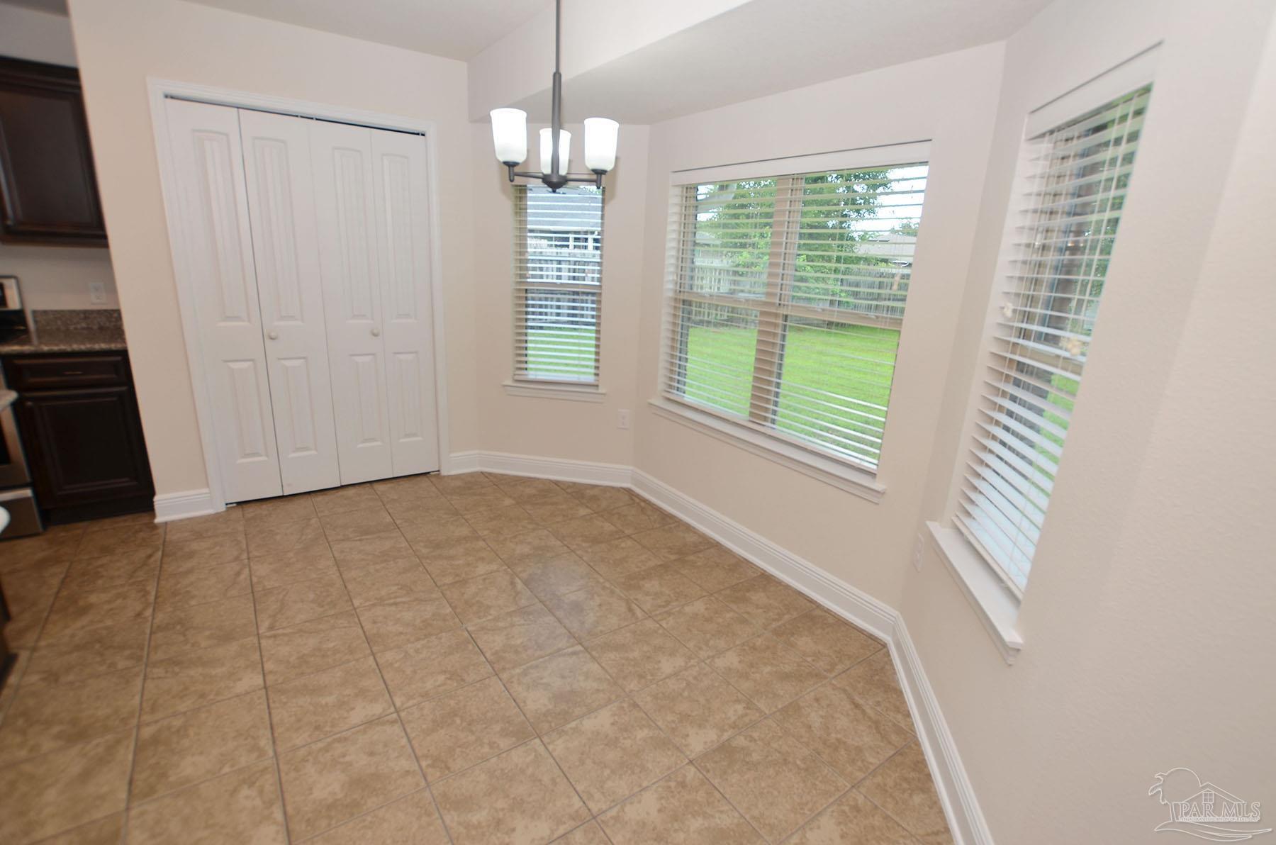 5709 Mill Stream Way Pace, FL 32571 - Photo 18 of 48 a view of an empty room with a window