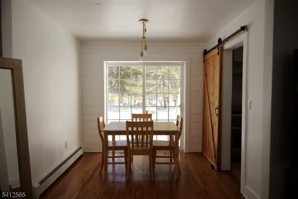 a view of a dining room with furniture window and wooden floor