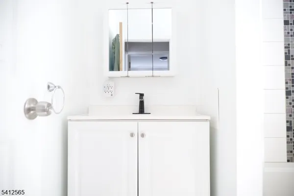 a bathroom with a sink and mirror
