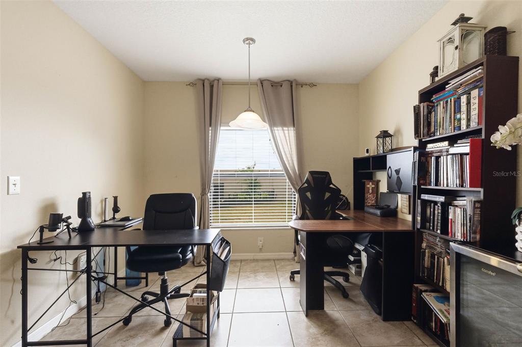 10135 Newminster Loop Ruskin, FL 33573 - Photo 14 of 35 a view of a workspace with furniture and a window