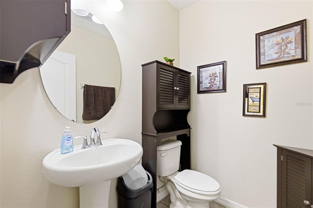 10135 Newminster Loop Ruskin, FL 33573 - Photo 18 of 35 a bathroom with a toilet sink and mirror
