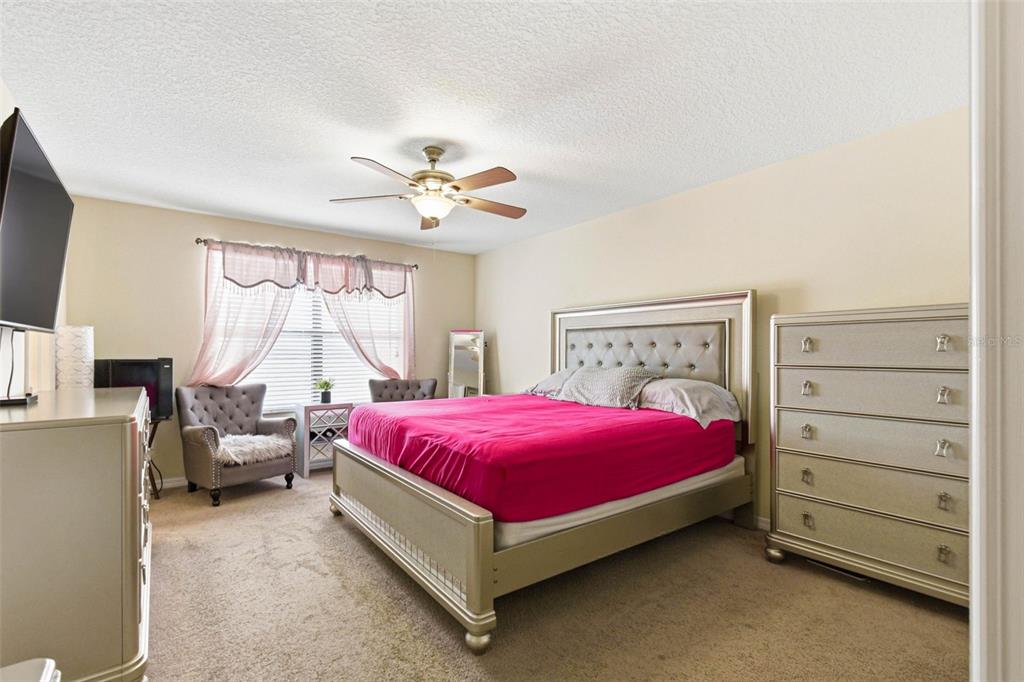 10135 Newminster Loop Ruskin, FL 33573 - Photo 19 of 35 a bed room with a bed and a window