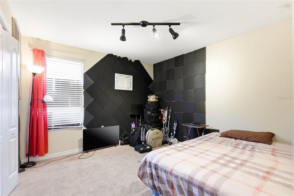 10135 Newminster Loop Ruskin, FL 33573 - Photo 24 of 35 a bedroom with bed and chair