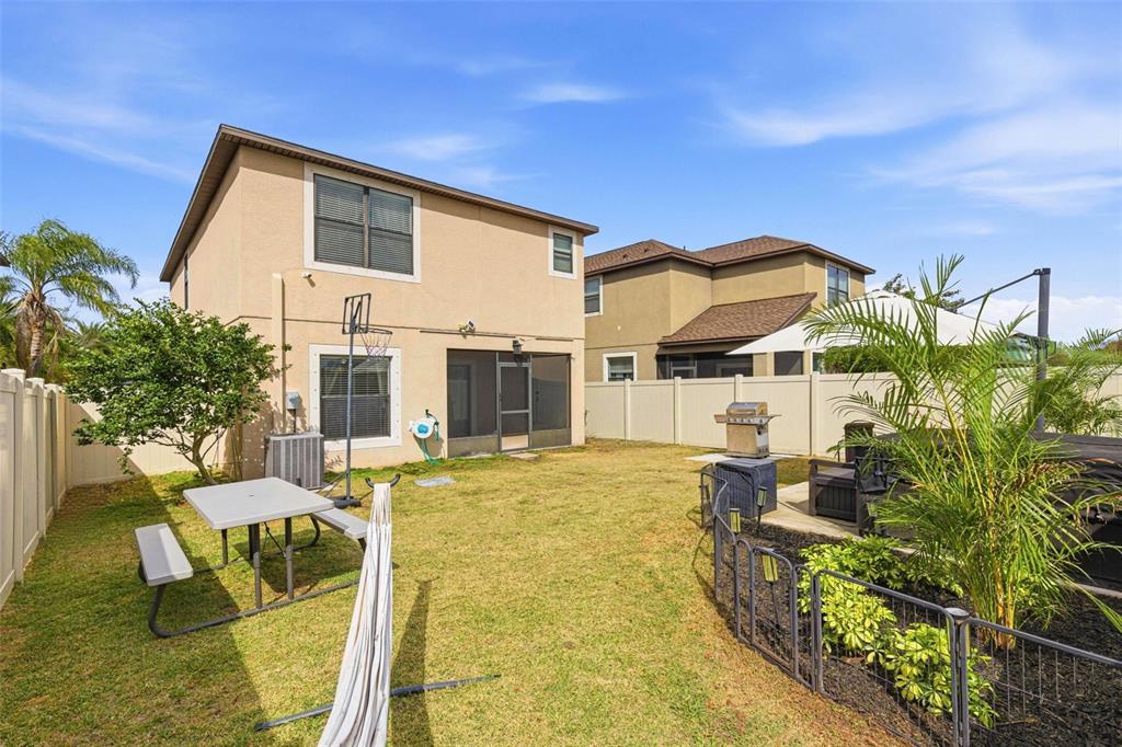 10135 Newminster Loop Ruskin, FL 33573 - Photo 32 of 35 a view of a house with backyard and sitting area