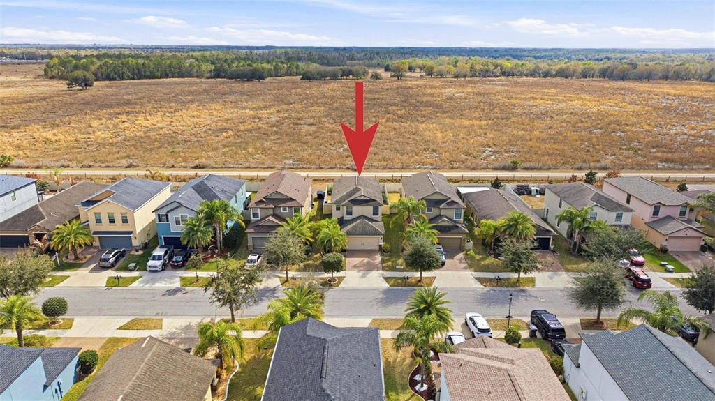 10135 Newminster Loop Ruskin, FL 33573 - Photo 34 of 35 an aerial view of residential building and lake