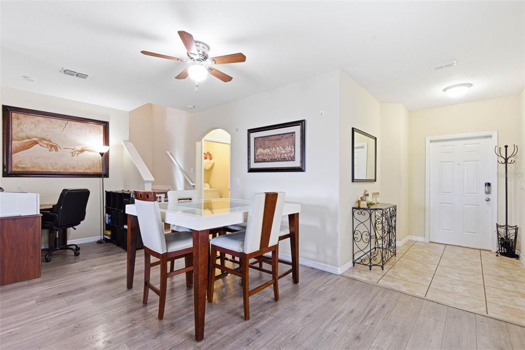 10135 Newminster Loop Ruskin, FL 33573 - Photo 4 of 35 a view of a dining room with furniture and wooden floor