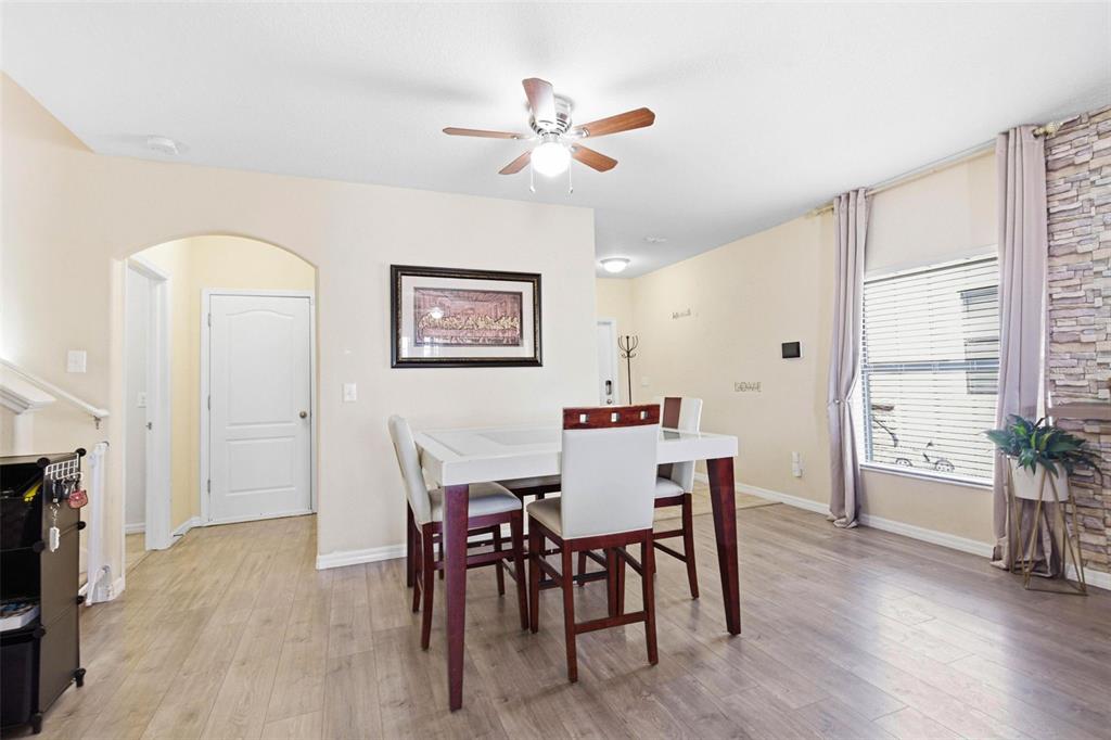 10135 Newminster Loop Ruskin, FL 33573 - Photo 5 of 35 a view of a a dining room with furniture window and wooden floor