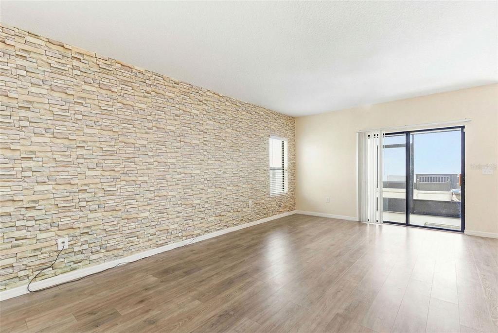 10135 Newminster Loop Ruskin, FL 33573 - Photo 9 of 35 wooden floor in an empty room with a window