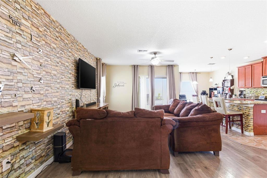 10135 Newminster Loop Ruskin, FL 33573 - Photo 10 of 35 a living room with furniture and a flat screen tv