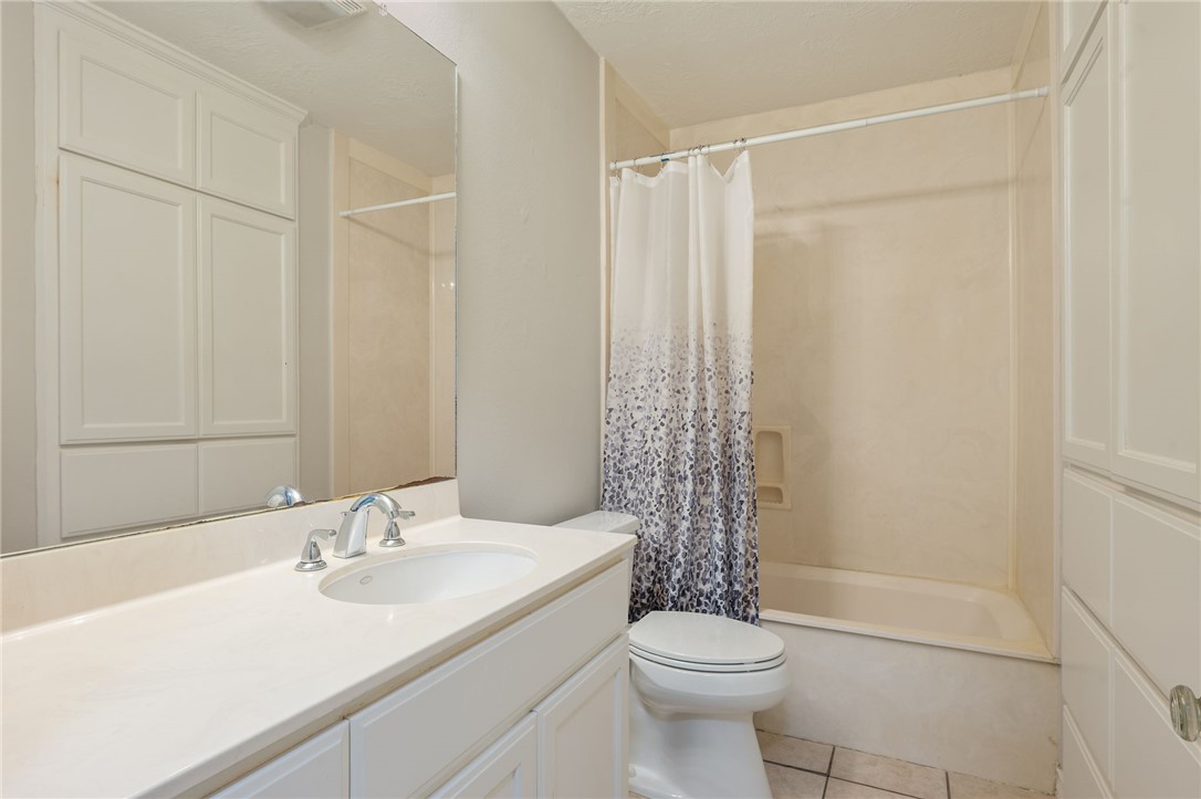 715 Inwood Drive Bryan, TX 77802 - Photo 30 of 34 a bathroom with a sink toilet and shower