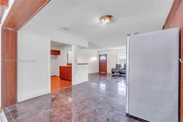 a view of livingroom with furniture and white cabinet