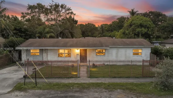 a view of a house with a backyard