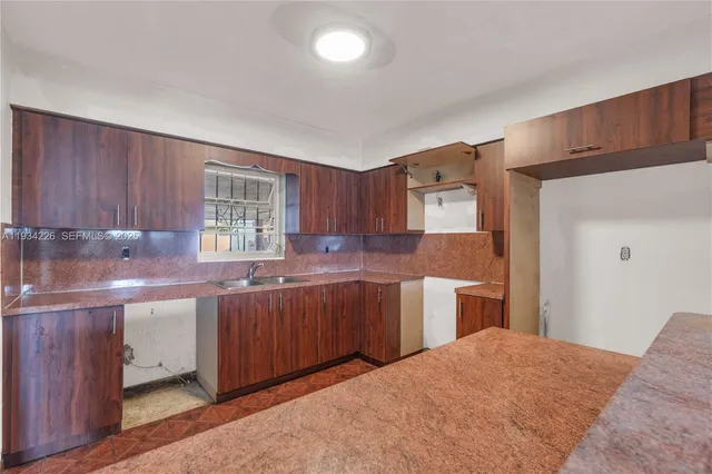 a kitchen with a sink and cabinets