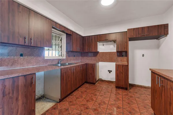 a kitchen with a cabinets and a stove top oven