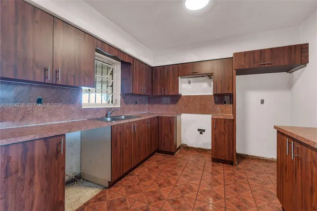 a kitchen with a cabinets and a stove top oven