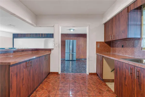 a kitchen with granite countertop a sink and cabinets
