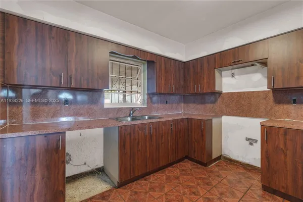 a kitchen with a sink and cabinets