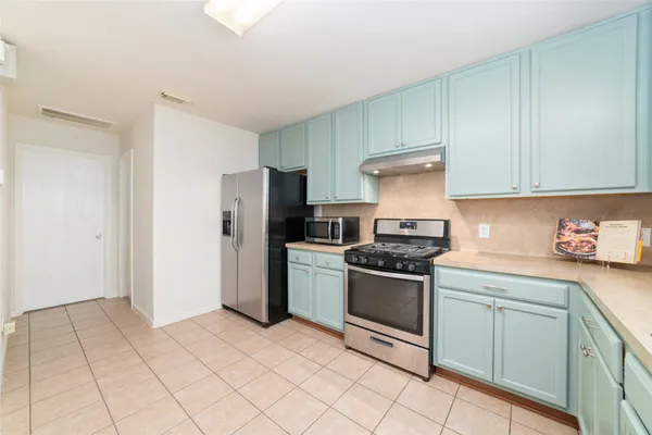 a kitchen with cabinets and appliances