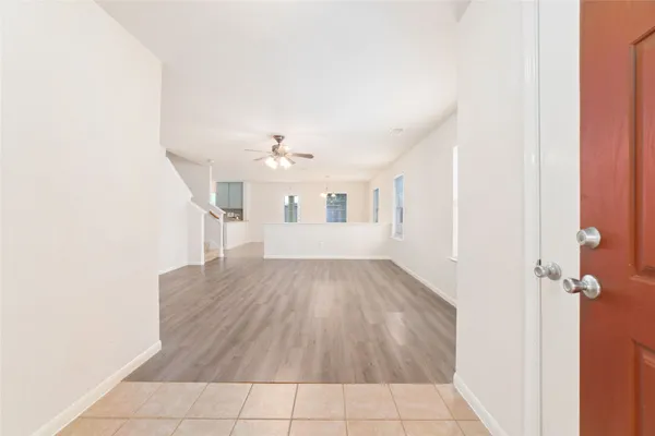 a view of a room with wooden floor and white walls
