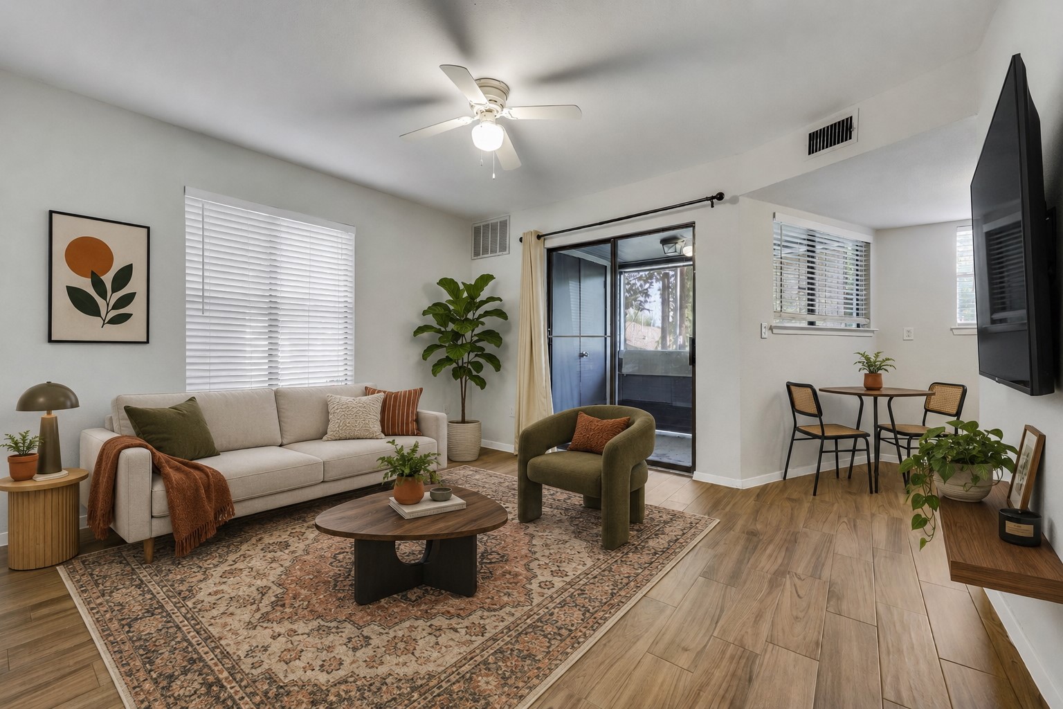 2500 Burleson Road, Unit 609 Austin, TX 78741 - Photo 1 of 32 Wood plank flooring extends across this luminous living area, featuring sliding glass doors to a balcony and a dedicated dining space.