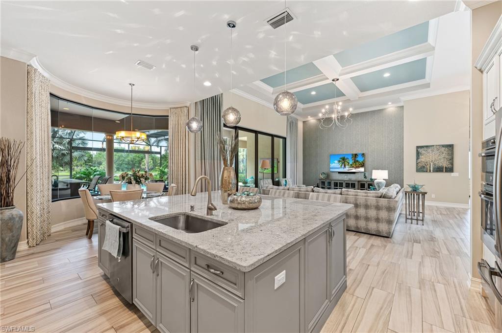11974 Maidstone Court Naples, FL 34120 - Photo 44 of 45 Kitchen with crown molding, gray cabinetry, coffered ceiling, a kitchen island with sink, and open floor plan