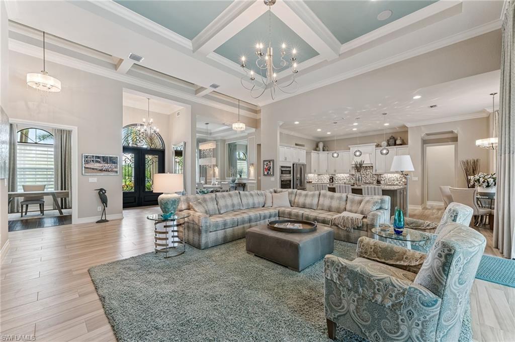 11974 Maidstone Court Naples, FL 34120 - Photo 18 of 45 Great room featuring a chandelier, beamed ceiling, coffered ceiling, ornamental molding