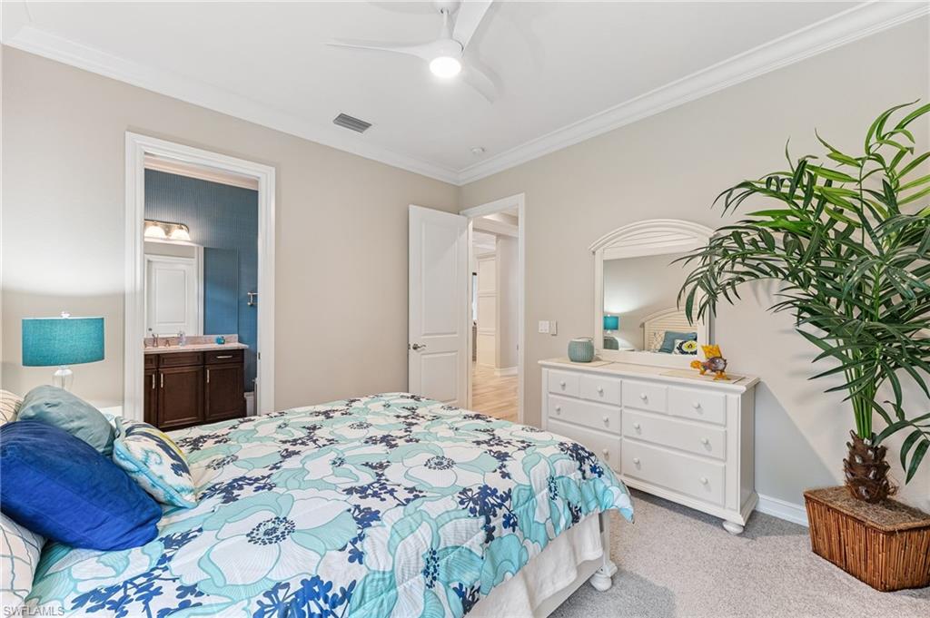 11974 Maidstone Court Naples, FL 34120 - Photo 21 of 45 Bedroom with crown molding, light colored carpet, ensuite bathroom, and ceiling fan
