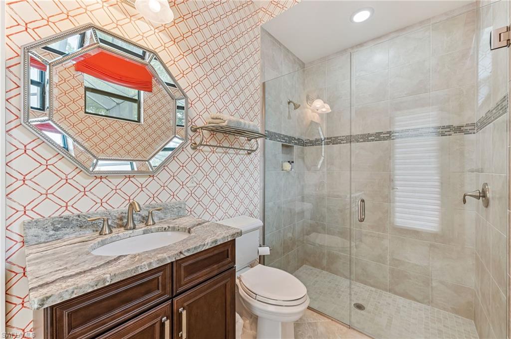 11974 Maidstone Court Naples, FL 34120 - Photo 28 of 45 Bathroom featuring vanity, a stall shower, a skylight, tile patterned floors, and recessed lighting