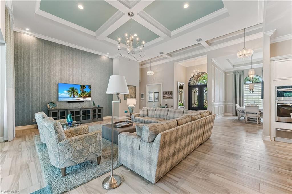 11974 Maidstone Court Naples, FL 34120 - Photo 29 of 45 Living area featuring a chandelier, ornamental molding, coffered ceiling, beamed ceiling, and recessed lighting
