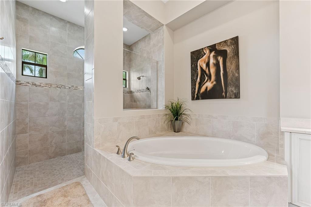 11974 Maidstone Court Naples, FL 34120 - Photo 37 of 45 Bathroom featuring a bath and a walk in shower