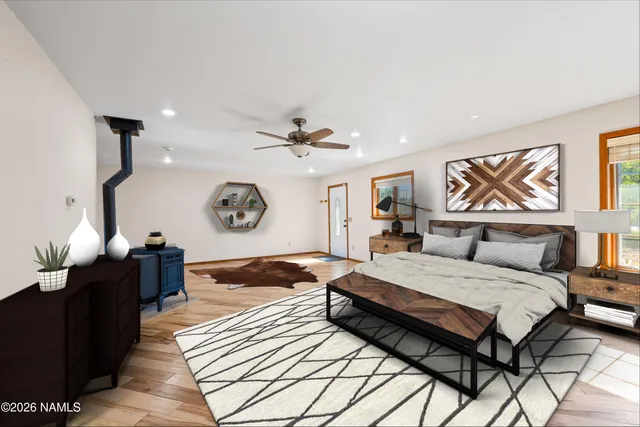 a bedroom with a bed and dresser with mirror