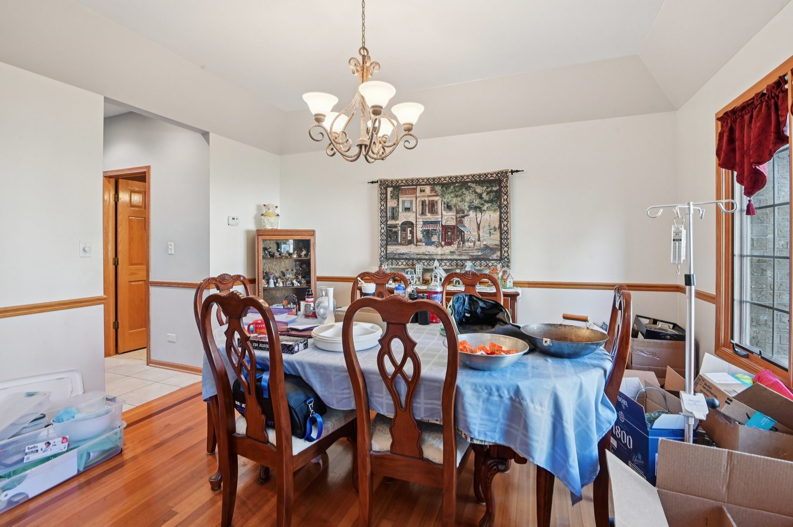 1575 Benton Street Crete, IL 60417 - Photo 18 of 66 a view of a dining room with furniture a chandelier and wooden floor