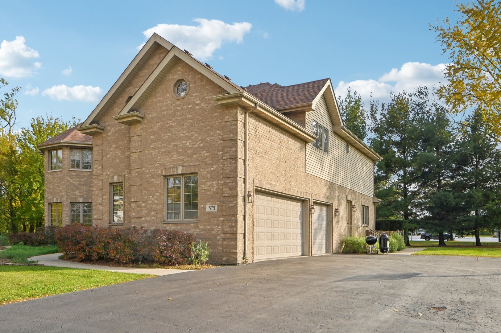 1575 Benton Street Crete, IL 60417 - Photo 2 of 66 a front view of a house with a yard and garage