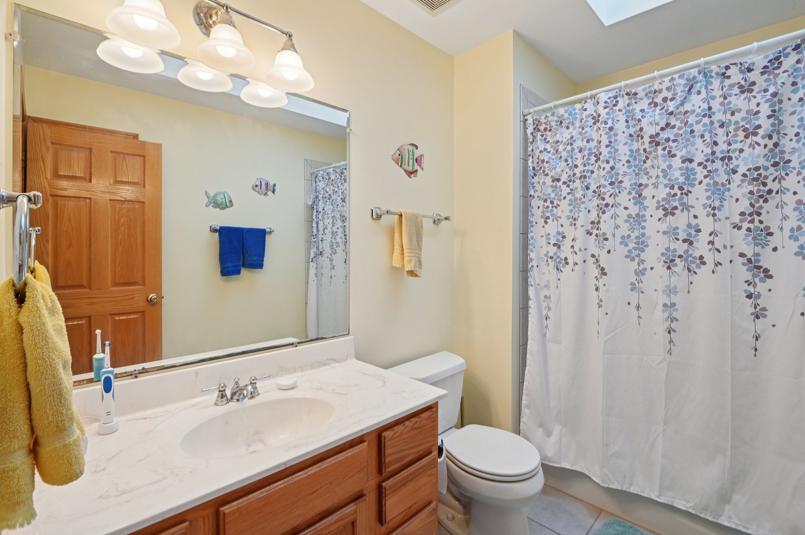 1575 Benton Street Crete, IL 60417 - Photo 30 of 66 a bathroom with a sink a toilet and shower curtain