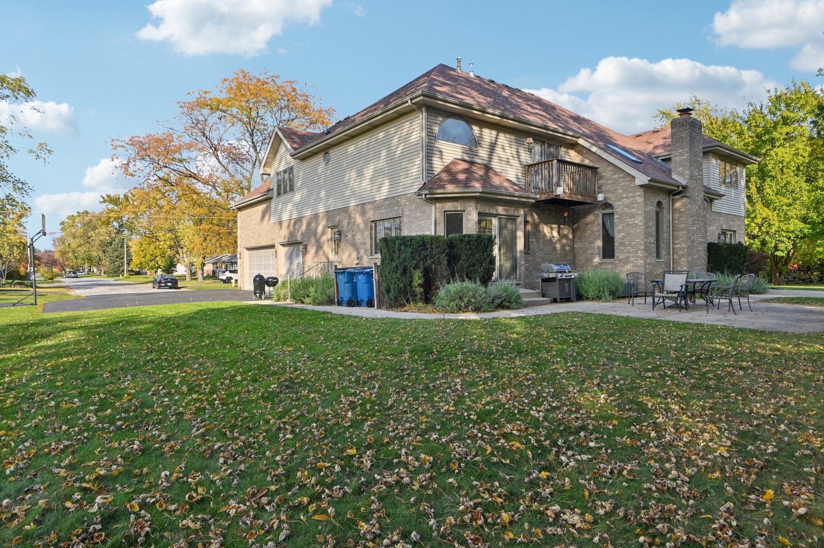 1575 Benton Street Crete, IL 60417 - Photo 3 of 66 a view of a white house with a big yard and large trees